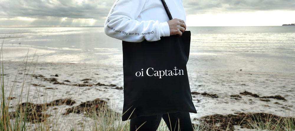 Limited Edition Organic Cotton Canvas Oi Captain Tote Bag is perfect for weekends to everyday.   Quality vinyl heat pressed Oi Captain logo on front and graphic type "Love the life you live and treat everyday like it's a weekend" on handle.  It is your ideal piece to wear any season, durable, sturdy, wonderful and fashionable way to carry things around.