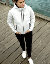 Elevate your casual weekend collection with the Carpe Diem Soft Essentials Hoodie. For all day comfort, this will be your go to.  Features trendy curved back, comfortable cotton bonded polar fleece lined hoodie jacket, drop shoulders add to this relaxed fit, and classic finishing touches, like zipped side pockets and piped trimmed edging. Quality vinyl heat pressed Oi Captain logo on front chest and lower back, and Licinia the label coastal collection set 2021 type graphic on sleeve.