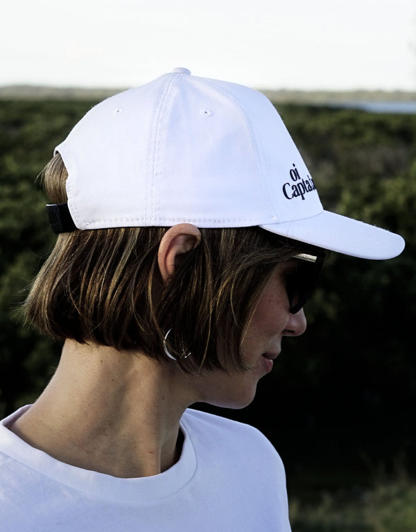 The Oi Captain Endless Summer Cap will quickly become your new favourite for any outdoor activity.  Made with an adjustable band back, structured front panel, and quality made finishes for total comfort. Unisex, one size fits All.  Stay protected in style with this on-trend classic cap.