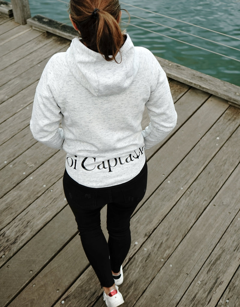 Elevate your casual weekend collection with the Carpe Diem Soft Essentials Hoodie. For all day comfort, this will be your go to.  Features trendy curved back, comfortable cotton bonded polar fleece lined hoodie jacket, drop shoulders add to this relaxed fit, and classic finishing touches, like zipped side pockets and piped trimmed edging. Quality vinyl heat pressed Oi Captain logo on front chest and lower back, and Licinia the label coastal collection set 2021 type graphic on sleeve.