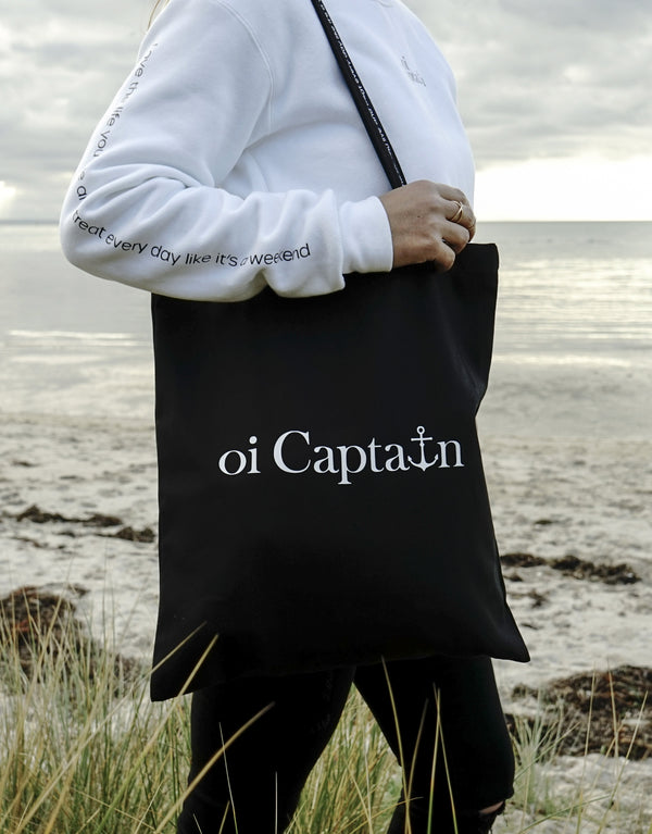 Limited Edition Organic Cotton Canvas Oi Captain Tote Bag is perfect for weekends to everyday.   Quality vinyl heat pressed Oi Captain logo on front and graphic type "Love the life you live and treat everyday like it's a weekend" on handle.  It is your ideal piece to wear any season, durable, sturdy, wonderful and fashionable way to carry things around.