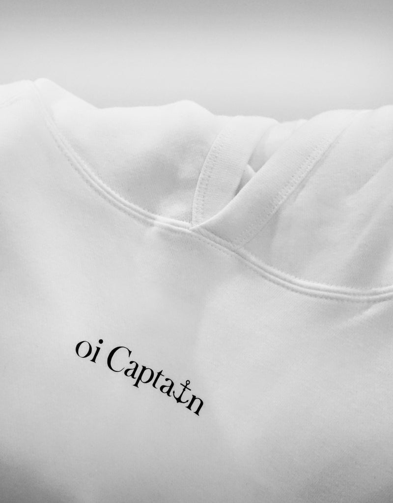 Your weekend just got a little better. Meet the Oi Captain Seas The Day classic fit hoodie.  Created from a cotton blend for instant comfy weekend vibes, crossover hood opening with rib trim applied to edge. Double-needle stitching at shoulder, neck, waistband & cuffs, and a handy kangaroo pocket. Quality vinyl heat pressed Oi Captain logo on front chest and Anchor, latitude and longitude graphic on back.